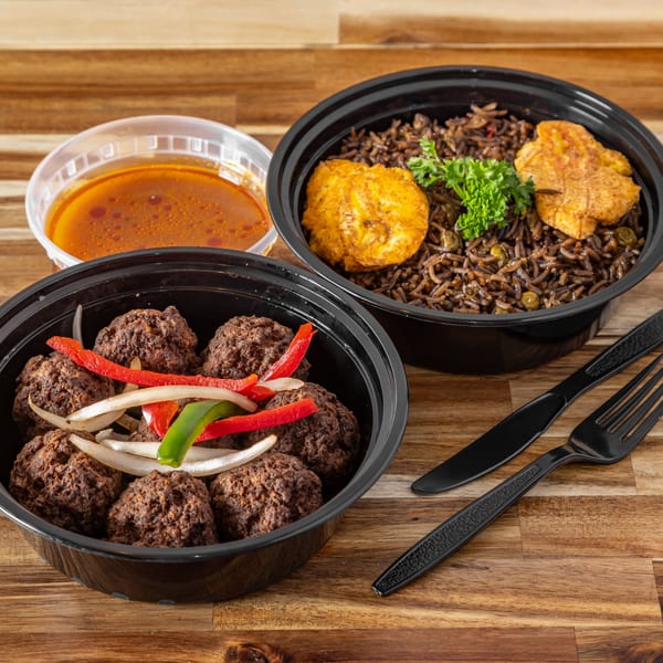 Two Haitian takeout containers with meatballs, rice, plantains, and a side of sauce.