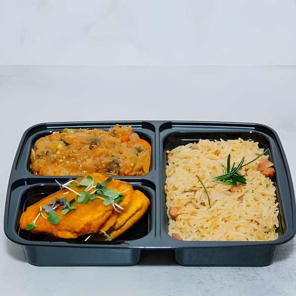 A Lakay Buffet takeout container with Haitian rice, plantains, and a vegetable stew.